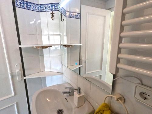 a small bathroom with a sink and a mirror at Gibralfaro Alojamiento Turístico cerca de la playa in Málaga