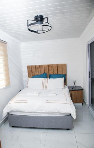 a bedroom with a large bed with a wooden headboard at one bedroom apartment A1 in Cape Town