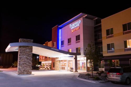 a hotel with a blue sign on the front of it at Fairfield Inn & Suites by Marriott Sheridan in Sheridan