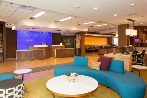 a lobby with a blue couch and a table at Fairfield Inn & Suites by Marriott Sheridan in Sheridan