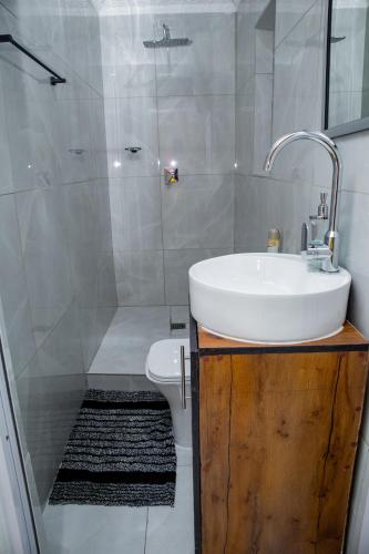 a bathroom with a sink and a toilet and a shower at one bedroom apartment A1 in Cape Town