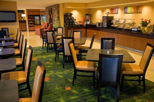a restaurant with tables and chairs and a bar at Fairfield Inn Spokane Downtown in Spokane