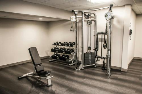 a room with a gym with weights at Four Points by Sheraton Allentown Lehigh Valley in Allentown