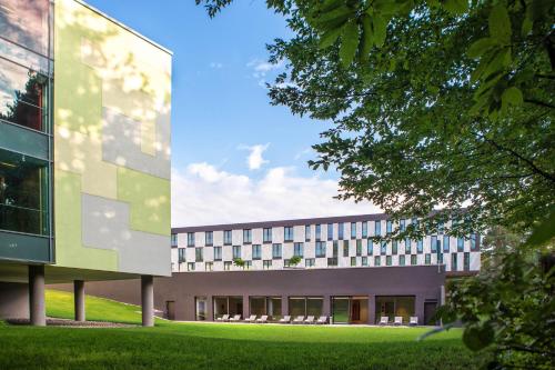 an external view of a building with a lawn at Four Points by Sheraton Ljubljana Mons in Ljubljana