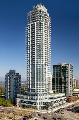 a tall building in a city with cars in front of it at Element by Westin Vancouver Metrotown in Burnaby