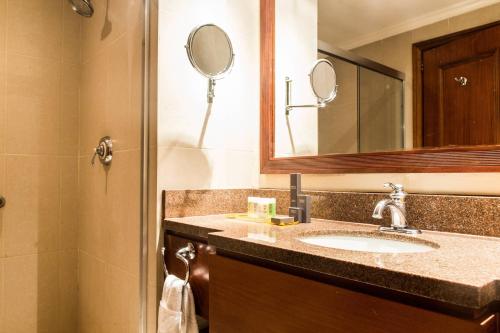a bathroom with a sink and a mirror at Marriott Venezuela Hotel Playa Grande in Playa Grande