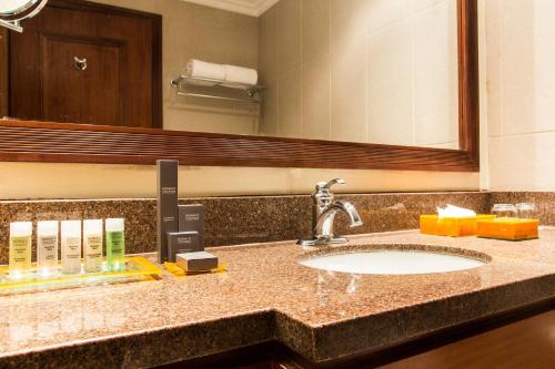 a bathroom counter with a sink and a mirror at Marriott Venezuela Hotel Playa Grande in Playa Grande