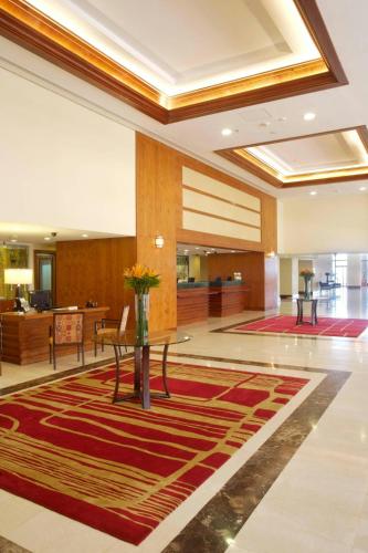 a lobby with a table with flowers on it at Marriott Venezuela Hotel Playa Grande in Playa Grande