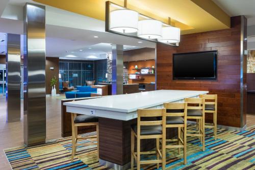 an office lobby with a large white counter and stools at Fairfield Inn & Suites by Marriott Fort Stockton in Fort Stockton