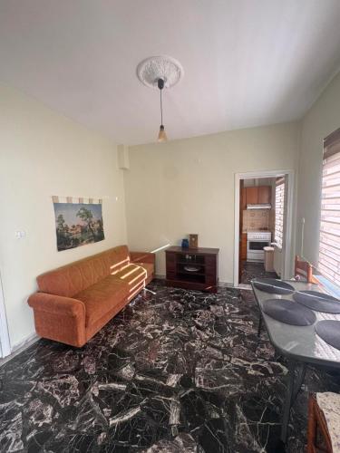 a living room with a couch and a table at Peaceful house in Alexandroupoli