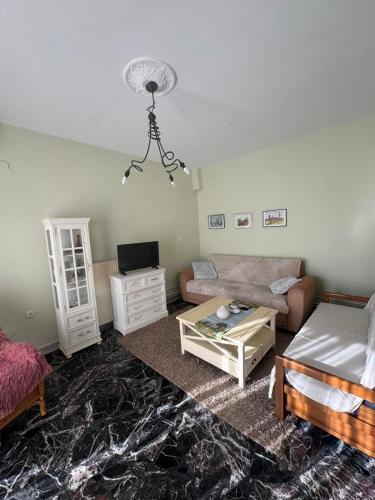 a living room with a couch and a table at Peaceful house in Alexandroupoli