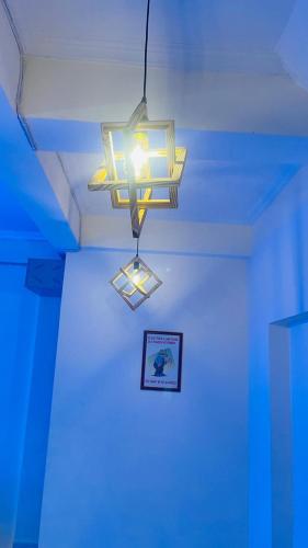 a light hanging from a ceiling in a room at The Gange Hill By Green Bird Hospitality in Rishīkesh