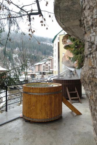 a wooden barrel sitting on top of a balcony at Синя гора in Bukovel