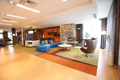 a living room with a blue couch and a table at Fairfield Inn & Suites by Marriott East Grand Forks in East Grand Forks