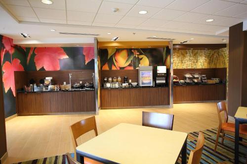 a waiting room with a table and chairs and a counter at Fairfield Inn & Suites by Marriott East Grand Forks in East Grand Forks