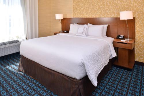 a hotel room with a large bed and a window at Fairfield Inn & Suites Farmington in Farmington
