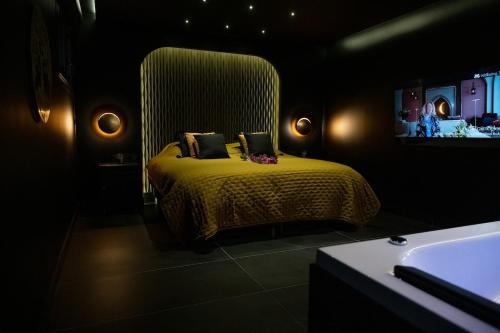 - une chambre avec un lit, une télévision et une baignoire dans l'établissement Baobab, à Corbas