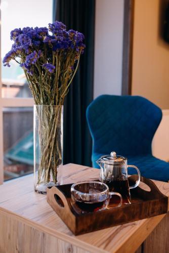 a table with a vase of flowers and a candle at Синя гора in Bukovel