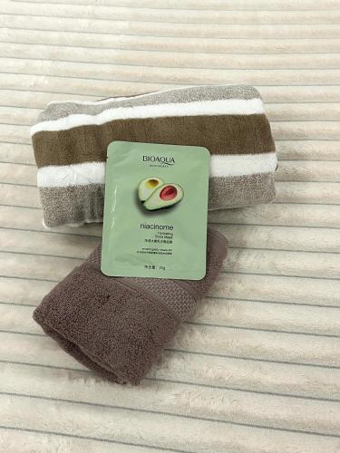 a book sitting on top of towels on a bed at By Room in Rumbula