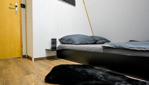 a bed sitting in a room with ainylinylinylinylinylinylinylinyl at Forest Escape with Jacuzzi & Pool Among the Trees by Destination GREEN Croatia in Ivanec