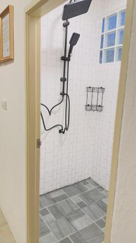 a shower with a shower head in a bathroom at Moon house Beach Hostel in Haad Rin