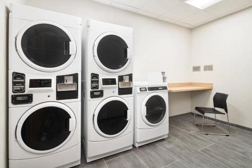 three washing machines in a room with a desk at Fairfield Inn & Suites Tampa Riverview in Riverview