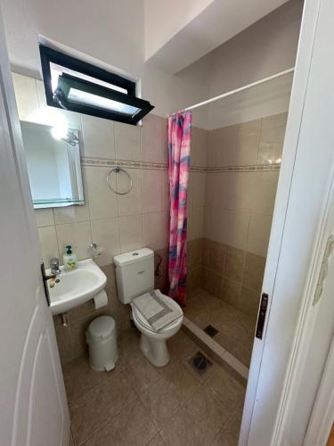 a bathroom with a toilet and a sink at Seapine Studios in Lassi