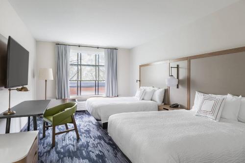 a hotel room with two beds and a desk at Fairfield Inn & Suites by Marriott Minneapolis North/Blaine in Blaine