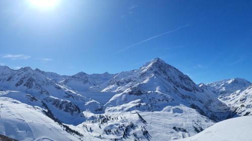 a snow covered mountain with a lake in front of it at HAGGNER Hideaway in Sankt Sigmund im Sellrain