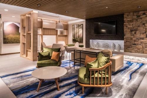 a living room with couches and a table at Fairfield Inn & Suites by Marriott Staunton in Staunton