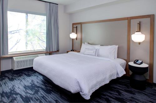 a hotel room with a large bed and a window at Fairfield Inn & Suites by Marriott Allentown West in Breinigsville