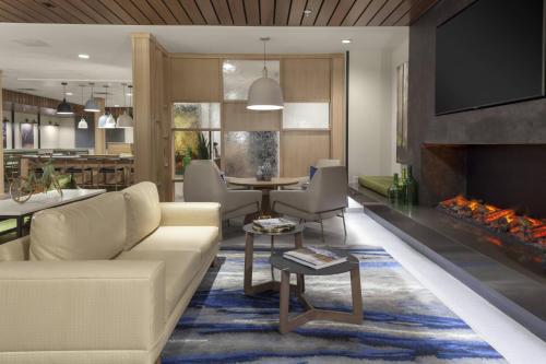 a living room with a couch and a fireplace at Fairfield Inn & Suites by Marriott Fort Collins South in Fort Collins