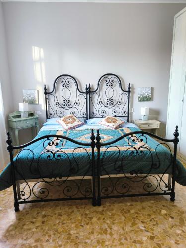 a bedroom with a large bed with a blue comforter at la Brunita in Rubiera