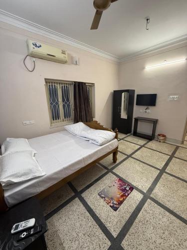 a bedroom with a bed and a air conditioner at The Tranquil Stay in kolkata