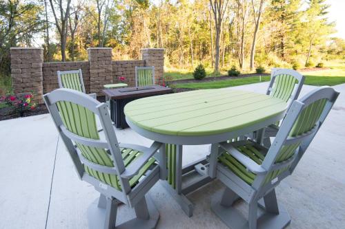 a picnic table with four chairs and a green table at Fairfield Inn & Suites by Marriott Fort Wayne Southwest in Ellison