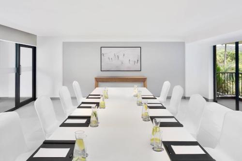 a long table in a white room with white chairs at Fairfield by Marriott Goa Anjuna in Anjuna