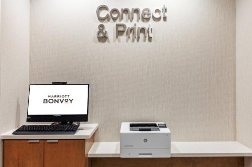 an office with a computer and a printer on a desk at Fairfield Inn & Suites by Marriott Tulsa Catoosa in Catoosa