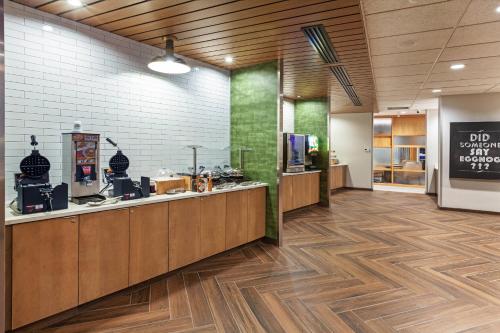 a restaurant with a counter in a room with aperature at Fairfield Inn & Suites by Marriott Tulsa Catoosa in Catoosa