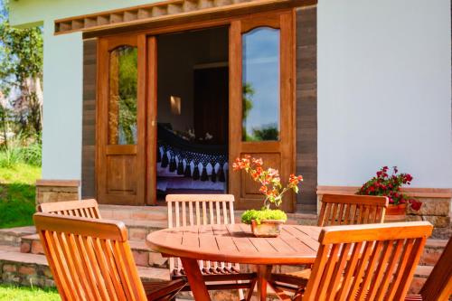 a wooden table and chairs on a patio at Casa de las Flores- Chalet Privado in Villa de Leyva