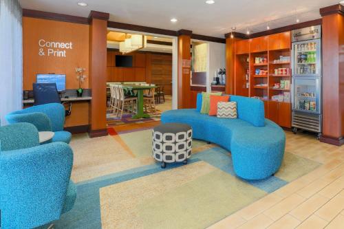 a waiting room with blue chairs and a table at Fairfield Inn & Suites by Marriott Yuma in Yuma