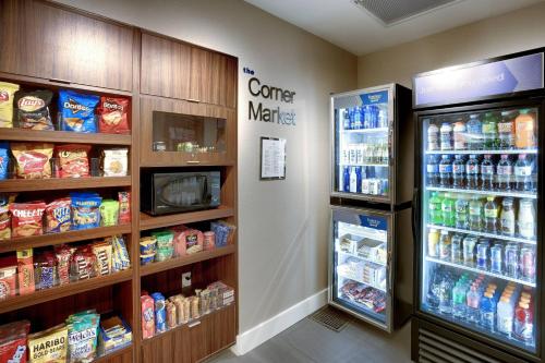 a store aisle with a refrigerator and a coffee maker at Fairfield Inn & Suites by Marriott Springfield North in Springfield