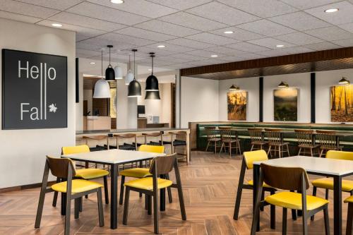 a dining room with tables and yellow chairs at Fairfield by Marriott Inn & Suites Bethlehem PA in Bethlehem