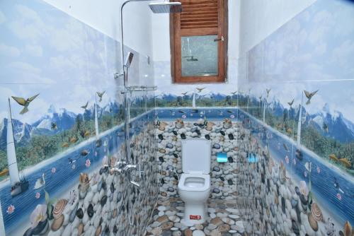 a bathroom with a flock of sheep on the wall at Ella Woodland 3 Arch Cottage in Ella
