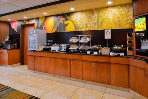 a food counter in a restaurant with food on it at Fairfield Inn and Suites by Marriott Fort Wayne in Fort Wayne