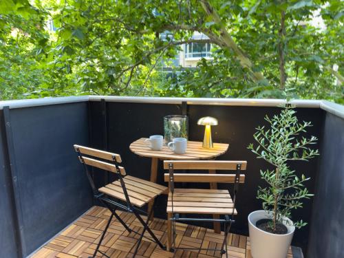 a small table and two chairs on a patio at Collins Escape - 2 bedrooms with Collins St Balcony in Melbourne