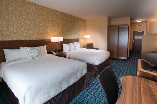 a hotel room with two beds and a table at Fairfield Inn & Suites by Marriott Houma Southeast in Houma