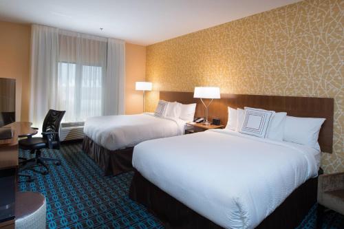 a hotel room with two beds and a desk at Fairfield Inn & Suites by Marriott Houma Southeast in Houma