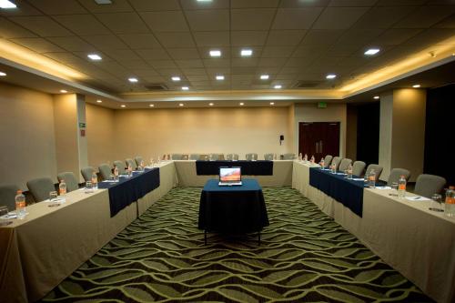 a conference room with a table with a laptop on it at Four Points by Sheraton Queretaro Norte in Querétaro