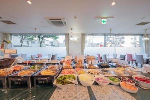 a long table filled with different types of food at Hotel Hakodate Royal Seaside BBH Hotel Group in Hakodate