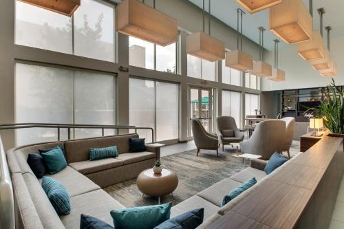 a living room with a couch and chairs and windows at Element Ewing Princeton in Ewing